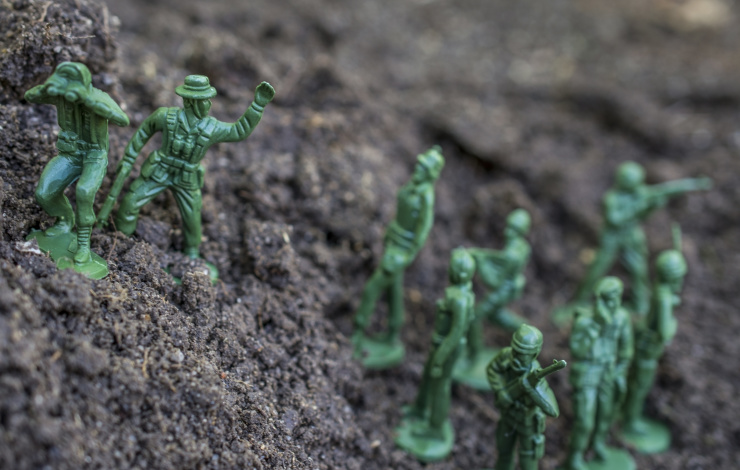 Action figures close-up. Toy soldiers following their leader.