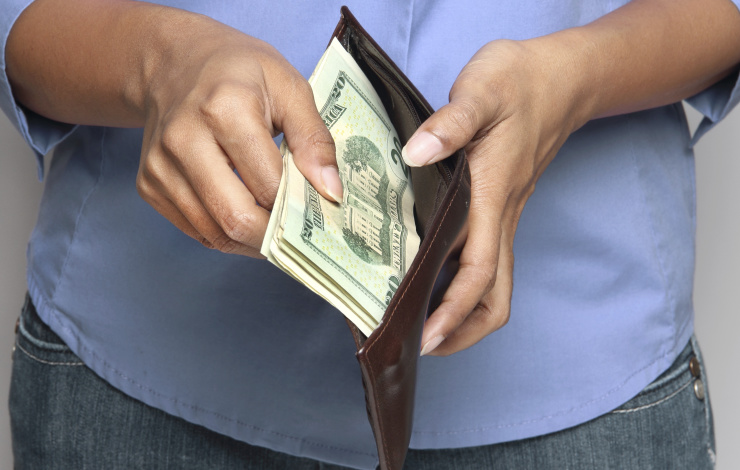 woman taking money out of a wallet
