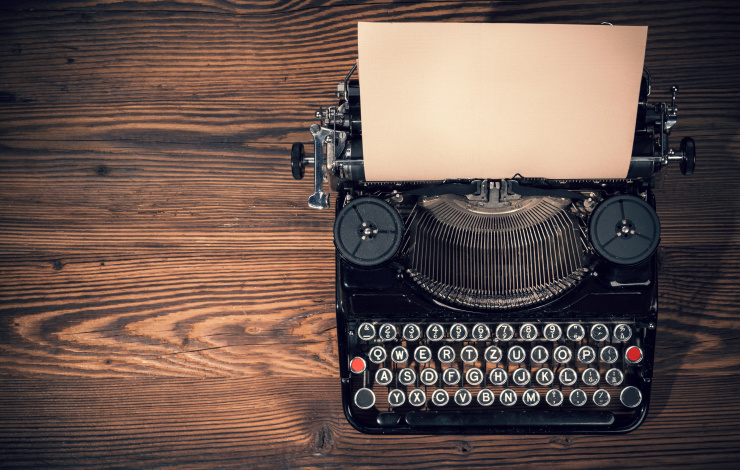 black typewriter on wood desk