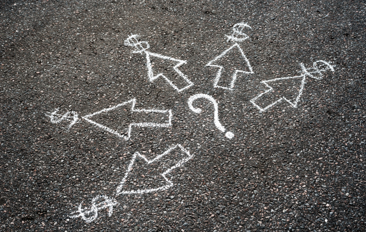 dollar signs and question mark drawn on asphalt with chalk