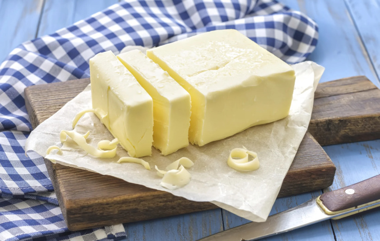 stick of butter on a cutting board