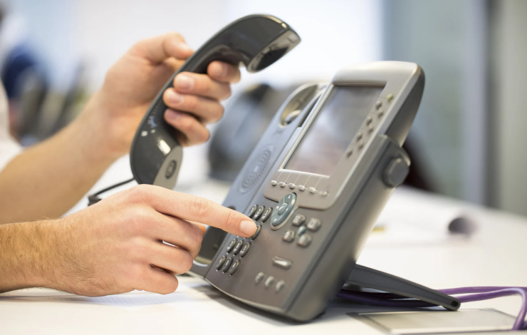 man picking up phone to make a call
