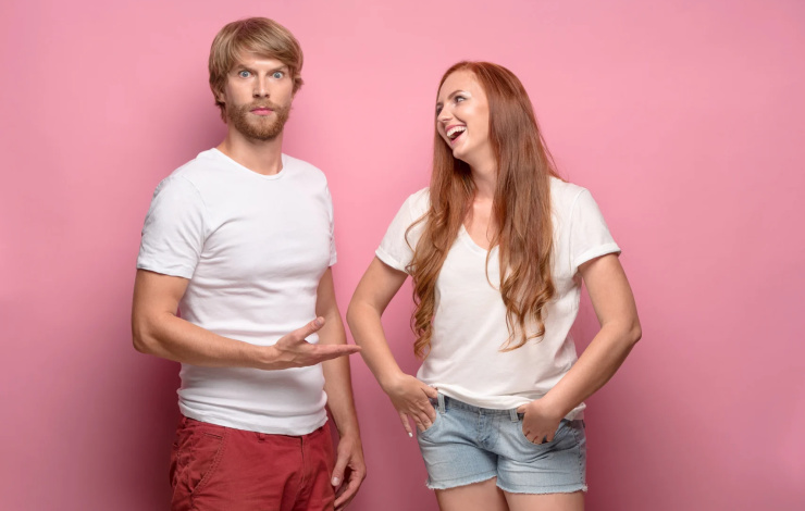 The young couple with different emotions at studio. Concept of love and dislike