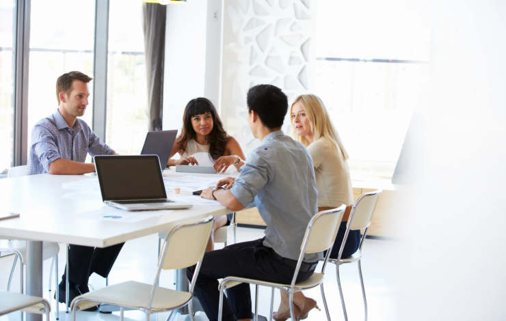 four coworkers in a meeting