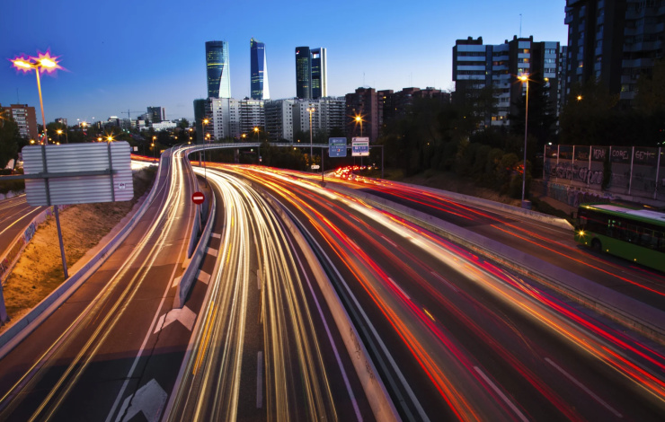 image of a cityscape with highway traffic blurred