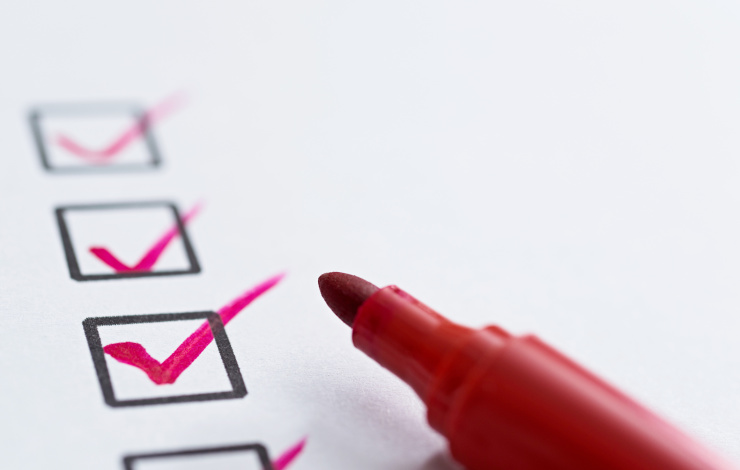 checklist with red pen on white background