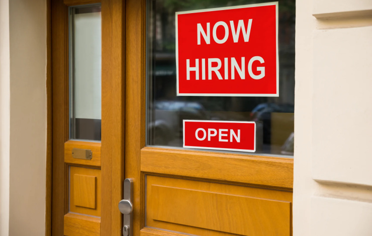 The Text Now Hiring Sticker Attached On Glass Door Of The Office