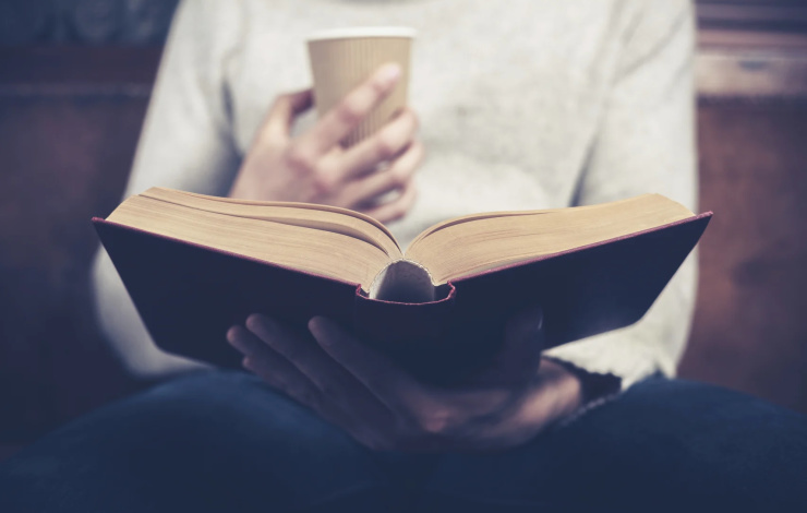 reading a book with a cup of coffee