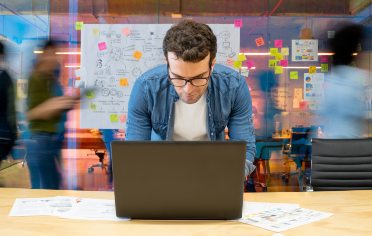 Guy using a laptop in a shop
