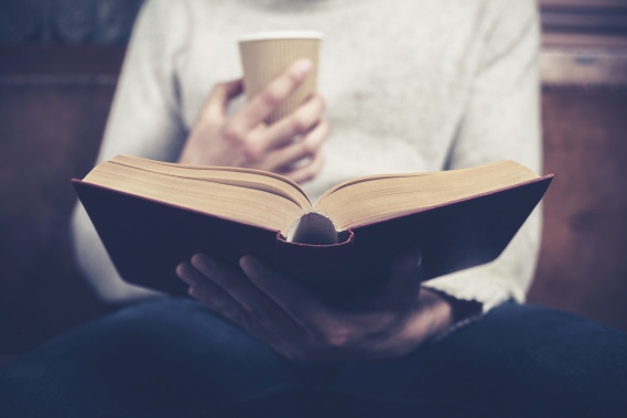 reading a book with a cup of coffee