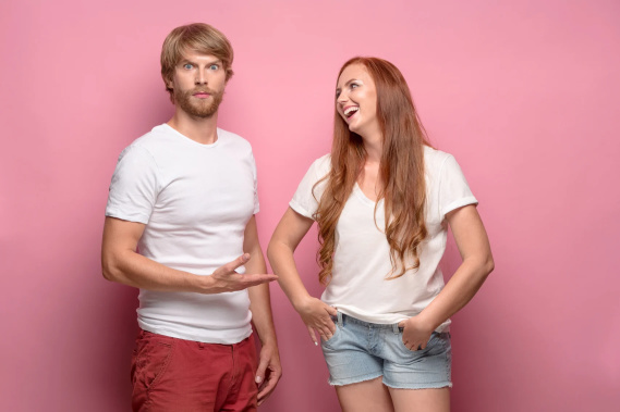 The young couple with different emotions at studio. Concept of love and dislike