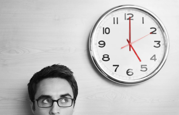 man looking at clock