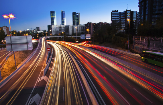 image of a cityscape with highway traffic blurred