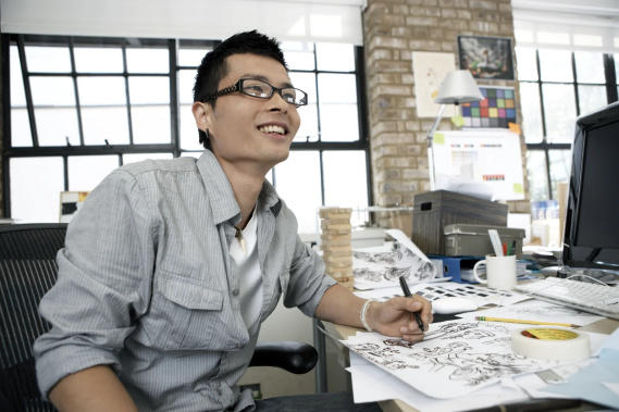 Happy young employee at desk