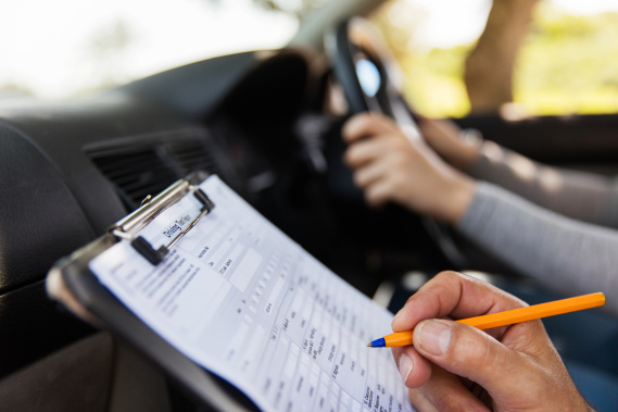 teenager being graded on a driving test
