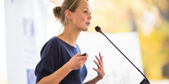 A woman speaking at a conference.