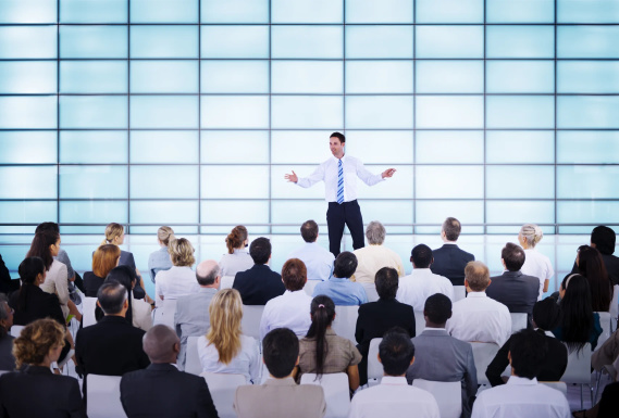 at a business conference listening to a speaker