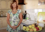 Yvonne Halling smiling on her couch