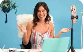 Keap user smiling at her laptop.