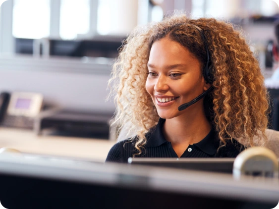 Keap customer support employee talking with customer on phone headset