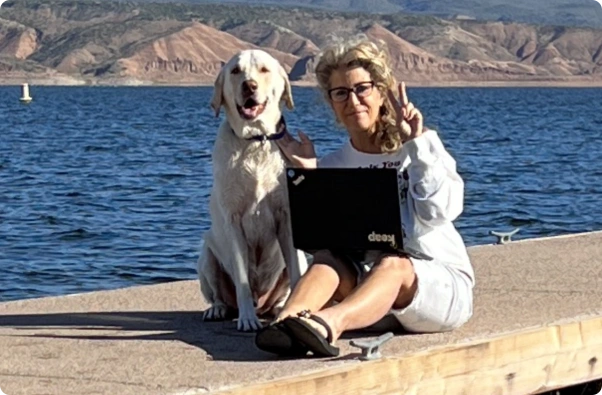 Judi with her dog near water