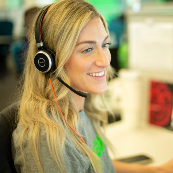 Image of a Keap support team member wearing a headset smiling