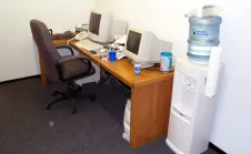 Picture of desk and computers in first real office space.