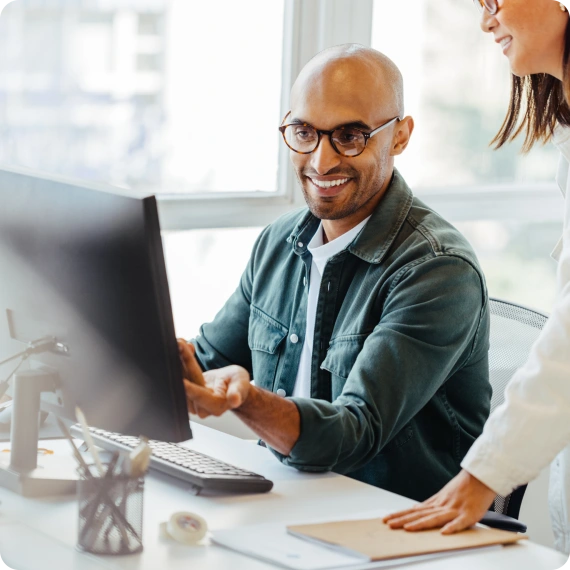 Man looking at a laptop excited