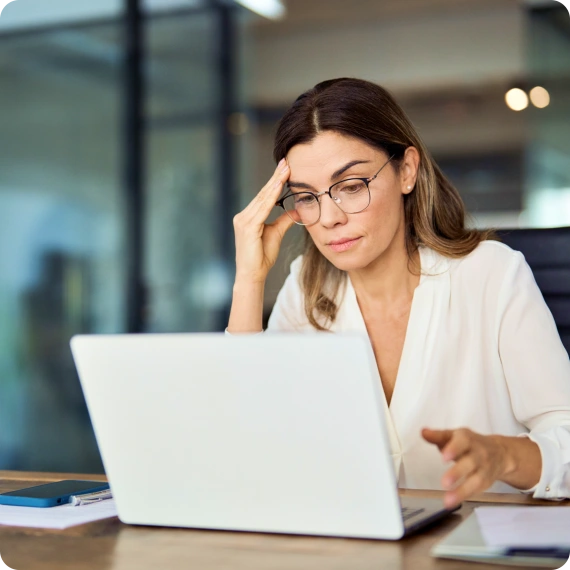 Woman looking at a laptop dissapointed