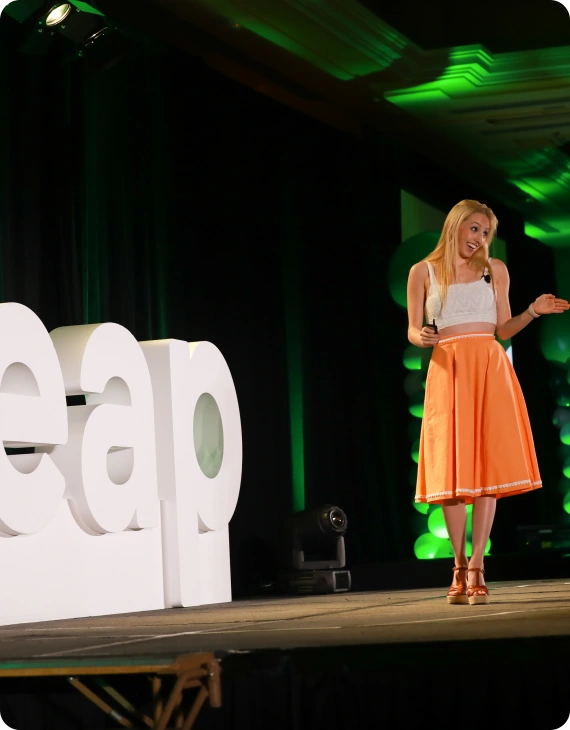 Woman standing on a stage smiling