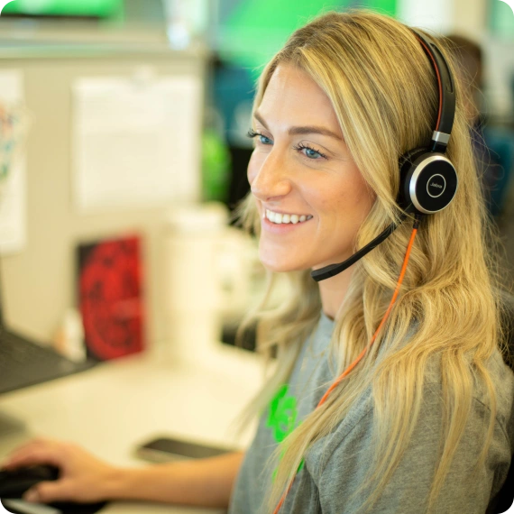 Keap woman support team member smiling and holding a headset