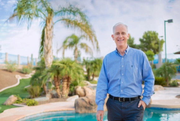 Picture of a Keap customer standing in front of a pool.