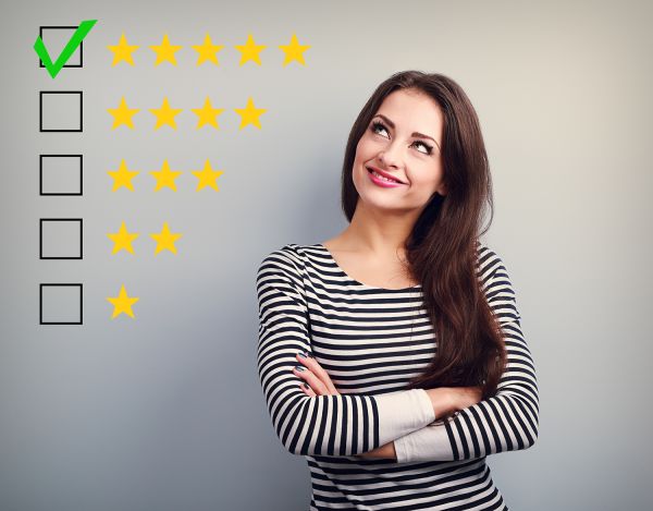 Girl looking at an illustration of 5-star rating with 5 stars selected