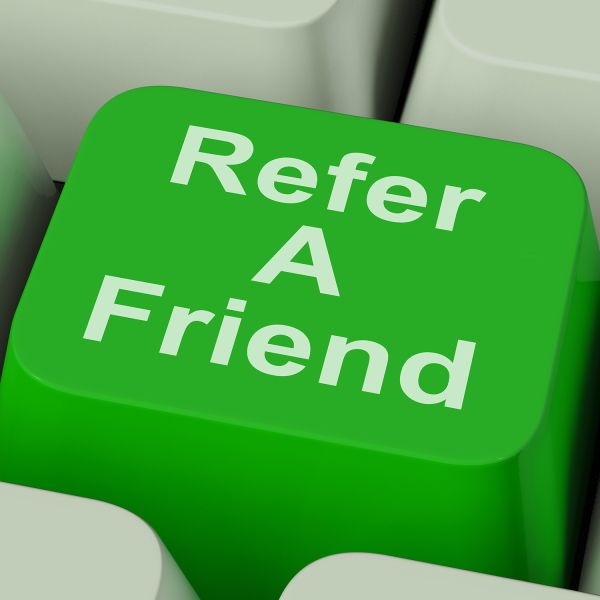 Close up of a keyboard key that says refer a friend