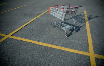 shopping cart abandoned in a parking lot