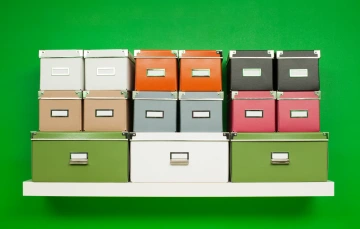 Different colored boxes on a shelf