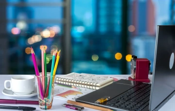 Desk with laptop and office supplies