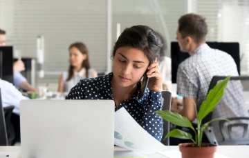 Woman talking on phone in office