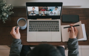 Person on laptop in video meeting