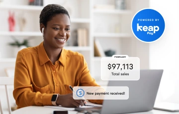 Woman smiling looking at laptop screen