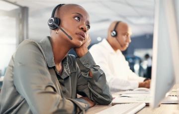 Two people on a computer headset