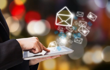 Illustration of envelops floating into the air from a tablet