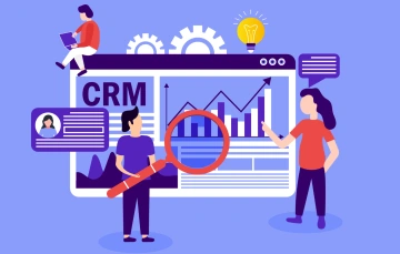 Three people looking at a picture of a CRM dashboard