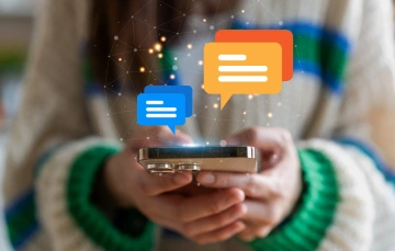 Woman holding smart phone with message graphics