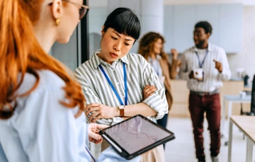 Frustrated business professional looking at a tablet, representing challenges with ineffective lead follow-up strategies