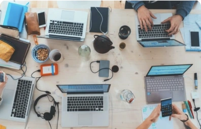 Image of a desktop with multiple people working at it
