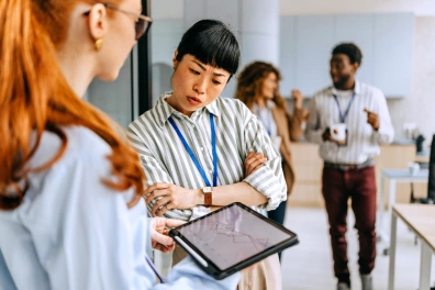 Frustrated business professional looking at a tablet, representing challenges with ineffective lead follow-up strategies