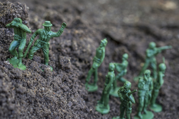 Action figures close-up. Toy soldiers following their leader.
