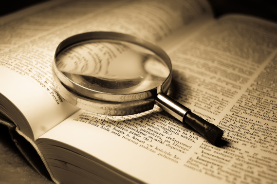 magnifying glass sitting on large case study book