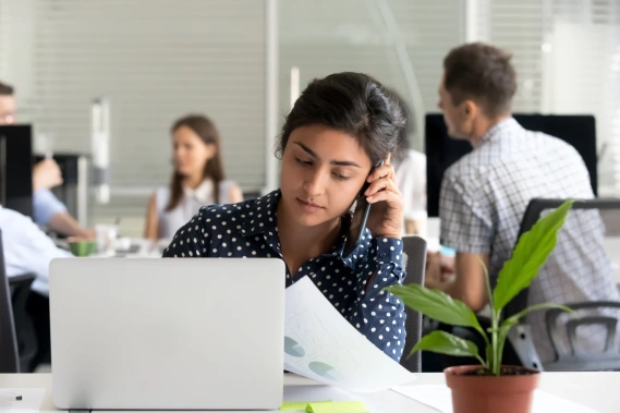 Woman talking on phone in office